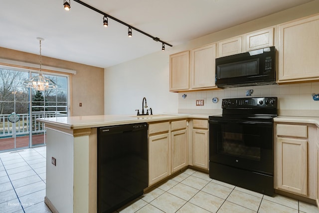 kitchen featuring backsplash, kitchen peninsula, black appliances, and a notable chandelier