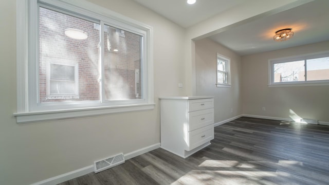 unfurnished room featuring dark wood-type flooring