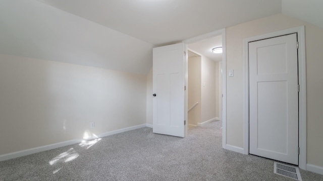 additional living space featuring carpet floors and lofted ceiling