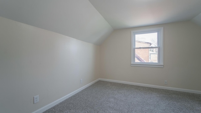 bonus room featuring carpet and vaulted ceiling