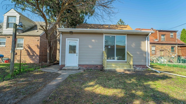 rear view of property with a lawn