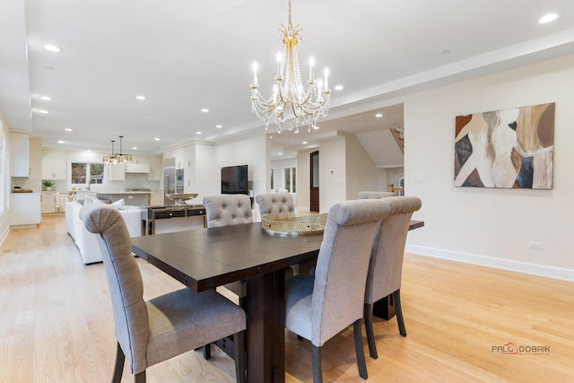 dining room with a chandelier and light wood-type flooring