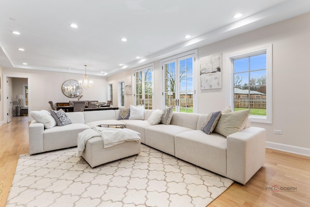 living room featuring an inviting chandelier and light wood-type flooring