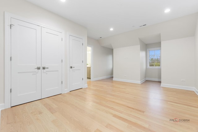 interior space with lofted ceiling and light wood-type flooring