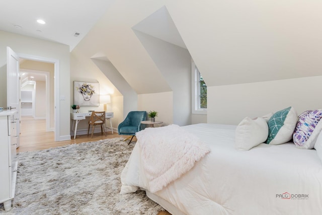 bedroom featuring light hardwood / wood-style flooring and vaulted ceiling