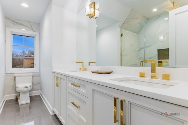 bathroom featuring vanity, toilet, and a shower with shower door