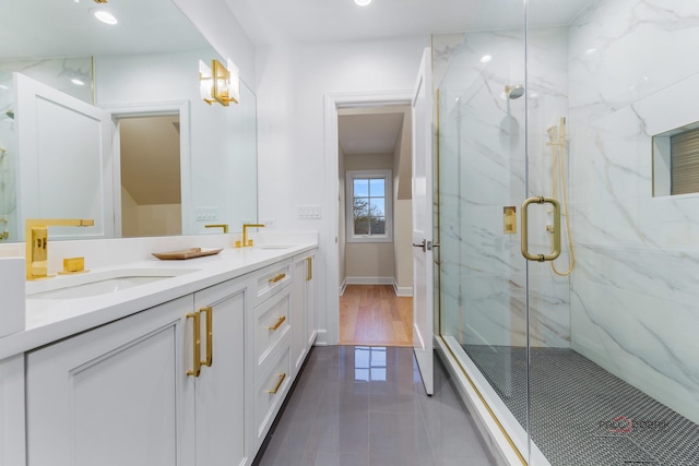 bathroom featuring tile patterned flooring, vanity, and a shower with shower door