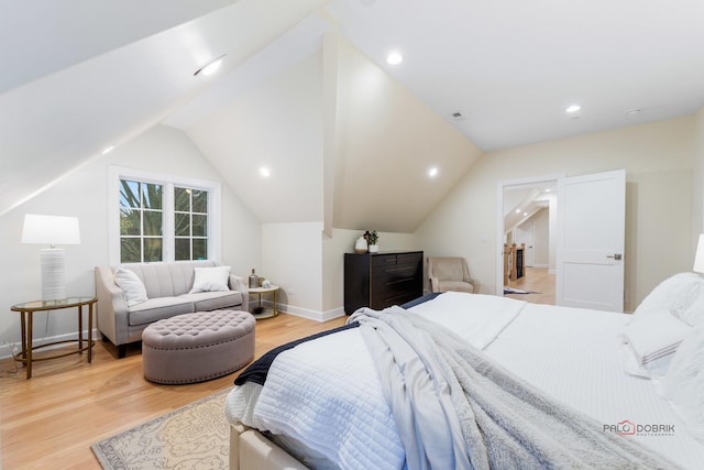 bedroom with hardwood / wood-style flooring and vaulted ceiling