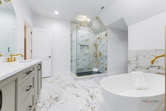 bathroom featuring vanity and shower with separate bathtub