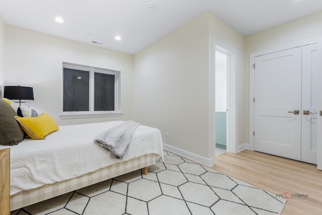 bedroom with a closet and light wood-type flooring