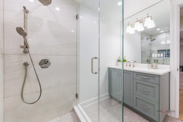 bathroom featuring tile patterned flooring, vanity, and walk in shower