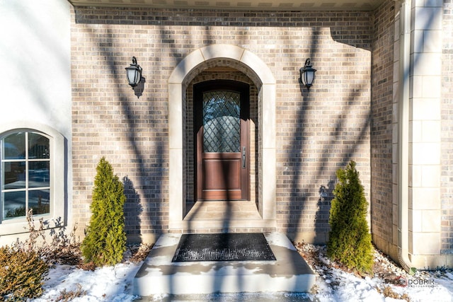 view of snow covered property entrance