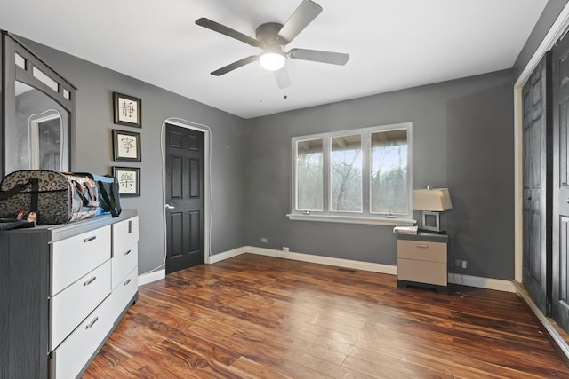 bedroom with ceiling fan and dark wood-type flooring