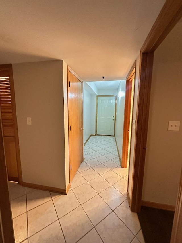 hall with light tile patterned floors