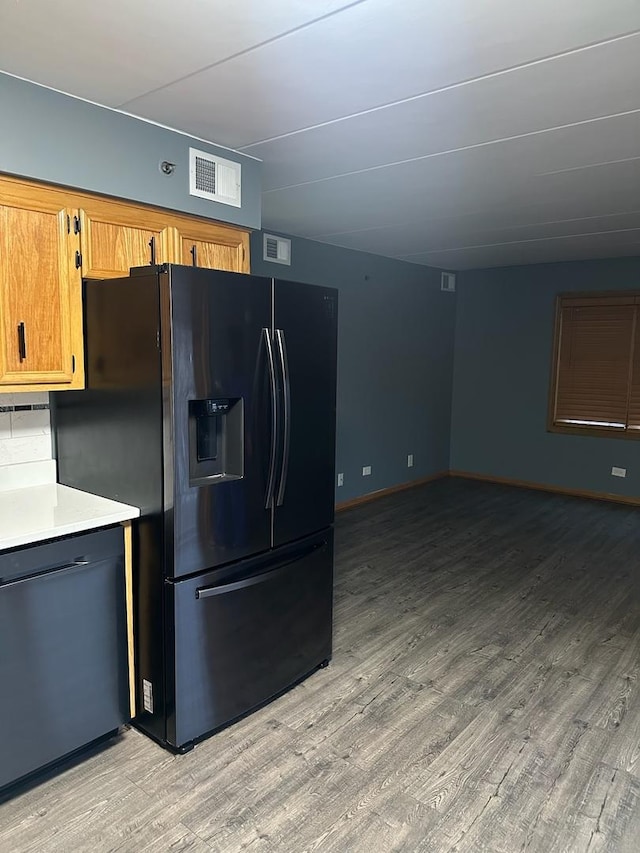 kitchen featuring black appliances and light hardwood / wood-style flooring