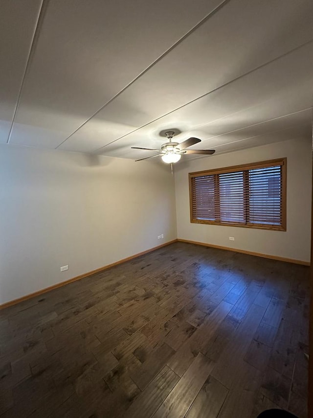 unfurnished room featuring ceiling fan and dark hardwood / wood-style flooring