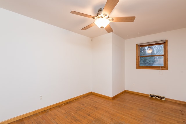 spare room with ceiling fan and wood-type flooring