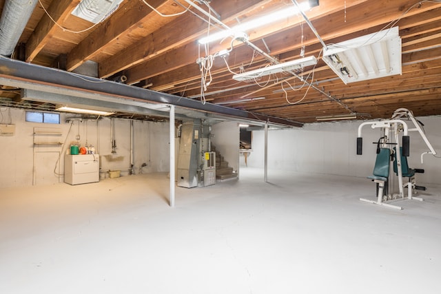 basement featuring washer / clothes dryer and heating unit