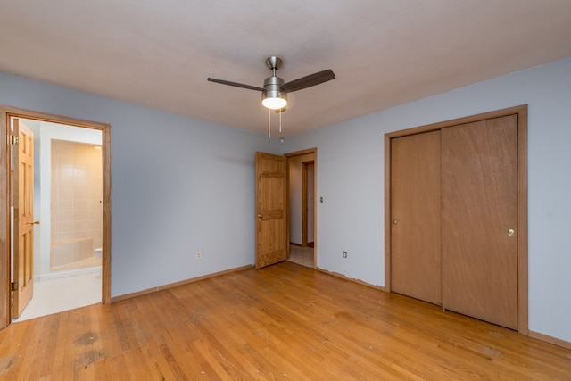 unfurnished bedroom featuring a closet, light hardwood / wood-style floors, ceiling fan, and ensuite bathroom