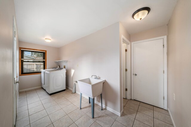 laundry area with light tile patterned floors and washer / clothes dryer