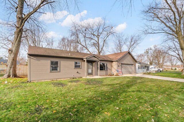 ranch-style house featuring a front yard and a garage