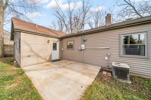 rear view of property featuring cooling unit and a patio area