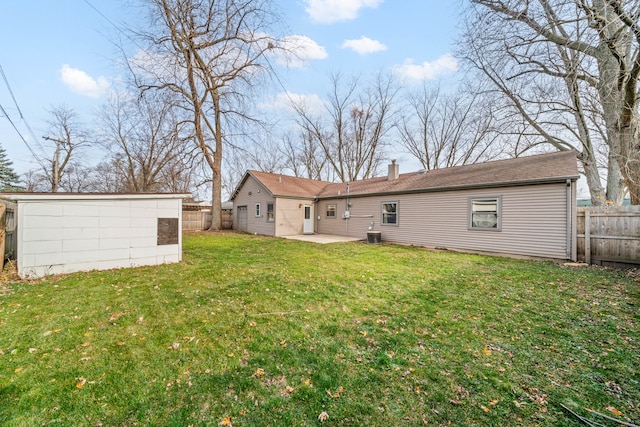 rear view of property with a lawn and a patio