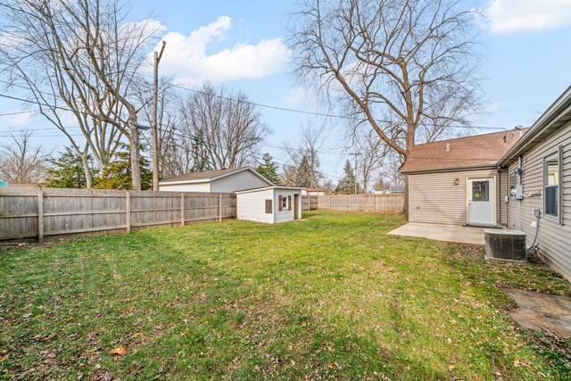 view of yard featuring central air condition unit and a patio area