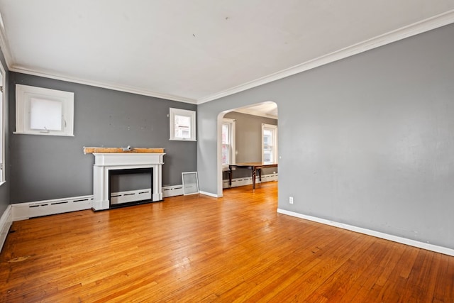 unfurnished living room with a baseboard heating unit, light hardwood / wood-style floors, and ornamental molding