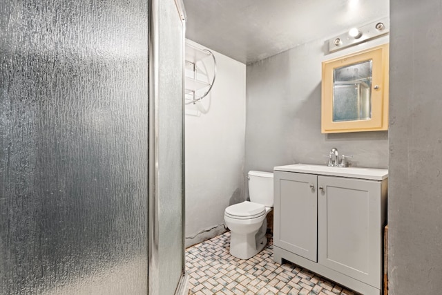 bathroom with vanity, toilet, and an enclosed shower