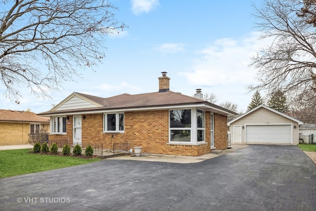 view of front of home with an outdoor structure and a garage