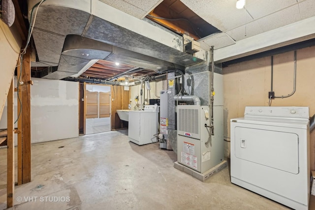 basement with washer / clothes dryer, heating unit, and water heater