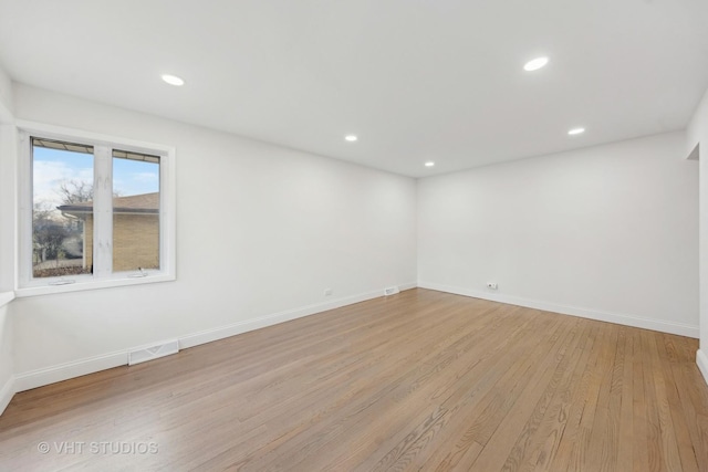 spare room featuring light wood-type flooring