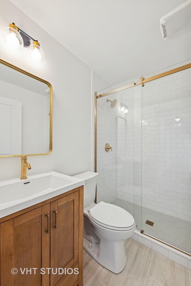 bathroom with vanity, toilet, and walk in shower