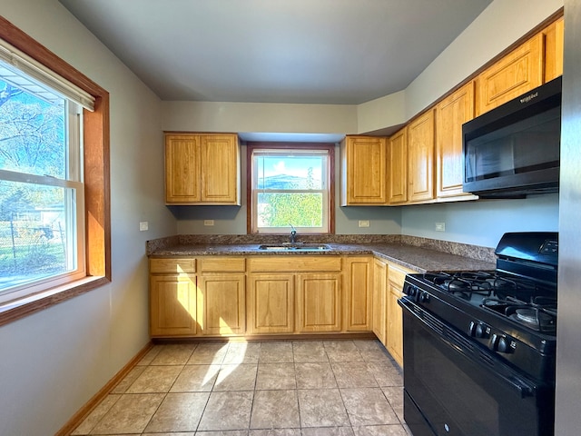 kitchen with black appliances, light tile patterned flooring, and sink