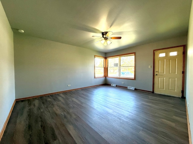 spare room featuring dark hardwood / wood-style floors and ceiling fan