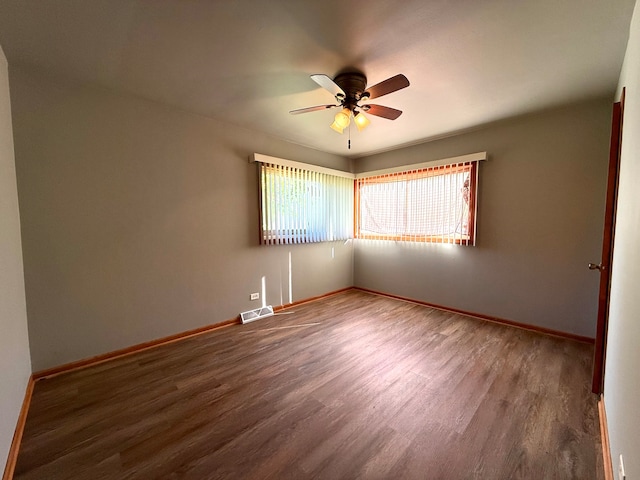 empty room with ceiling fan and hardwood / wood-style floors