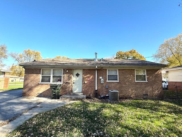 ranch-style home featuring central AC, a front lawn, and a patio area