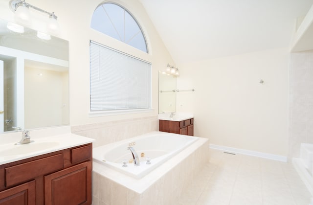 bathroom featuring tile patterned floors, tiled tub, vanity, and lofted ceiling