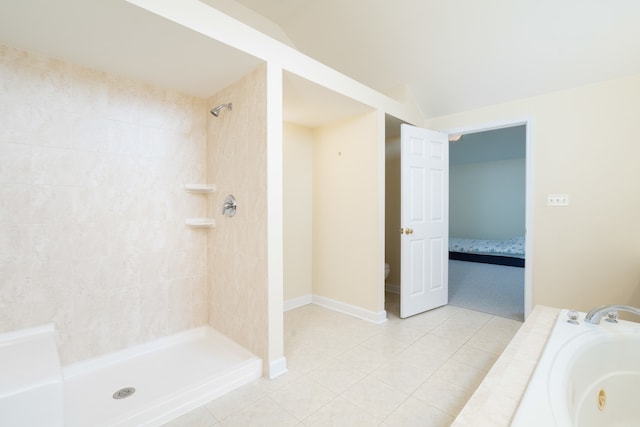 bathroom featuring tile patterned floors, toilet, a tile shower, and vaulted ceiling