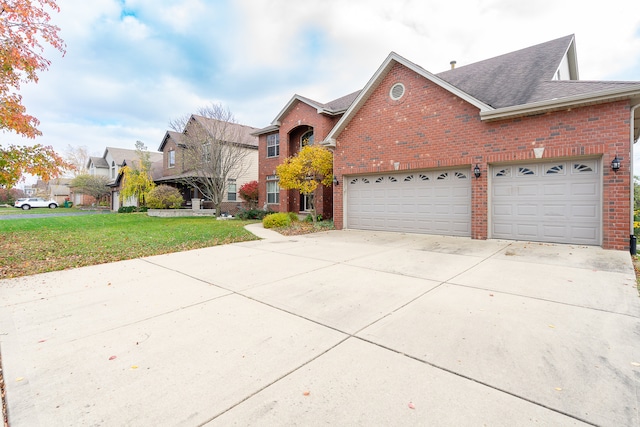 view of front of home with a front yard and a garage