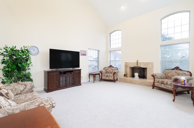 carpeted living room with high vaulted ceiling