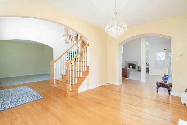 foyer featuring hardwood / wood-style floors and a chandelier