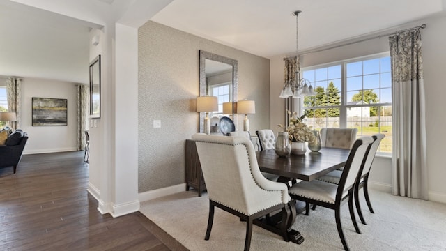 dining space featuring hardwood / wood-style flooring and a notable chandelier