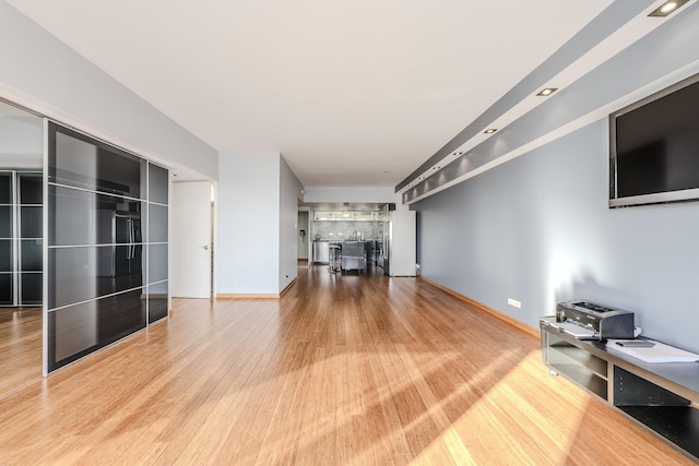 unfurnished living room with hardwood / wood-style flooring