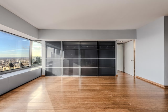 spare room with hardwood / wood-style flooring