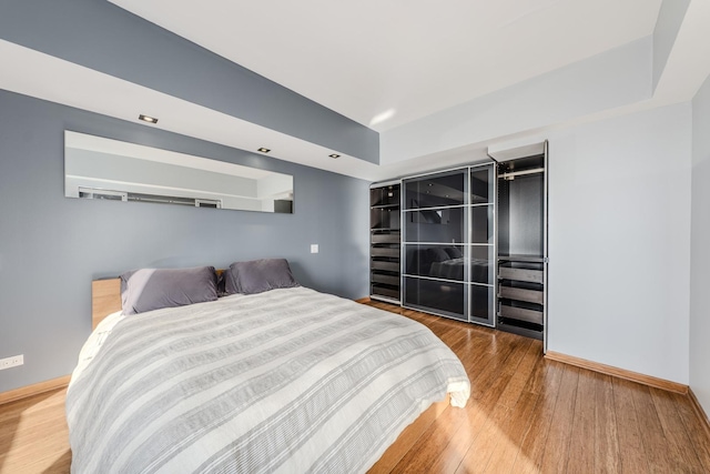 bedroom with wood-type flooring