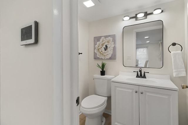 bathroom featuring tile patterned flooring, vanity, and toilet