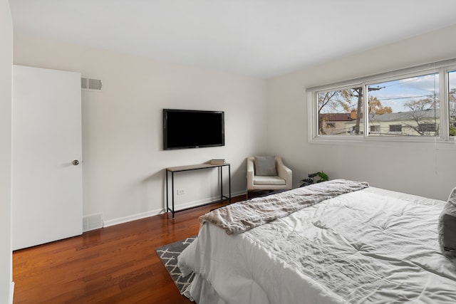 bedroom with dark hardwood / wood-style flooring