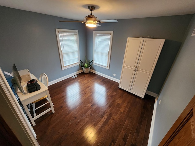 unfurnished dining area featuring ceiling fan and dark hardwood / wood-style flooring